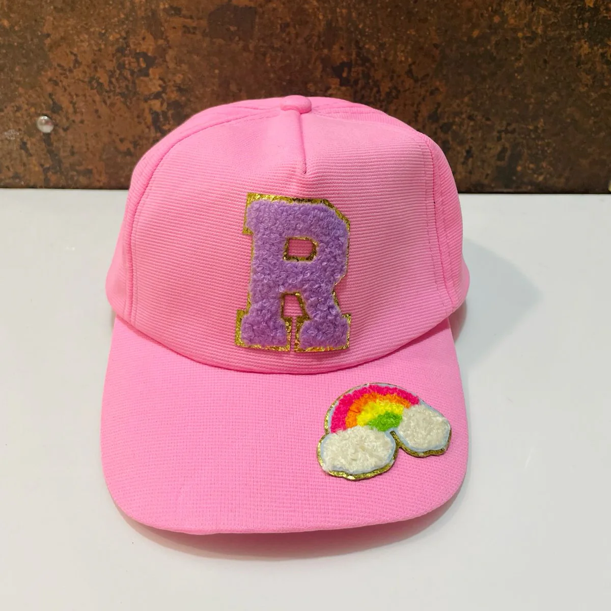Caps with initials and a charm